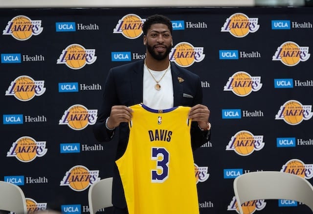 Los Angeles Lakers forward Anthony Davis holds his new No. 3 jersey during an introductory press conference